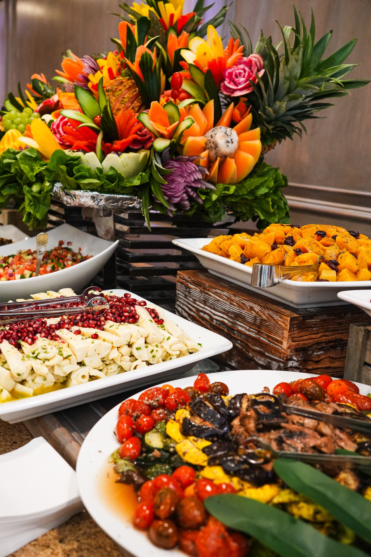 Kosher buffet display with carved fruit and vegetables