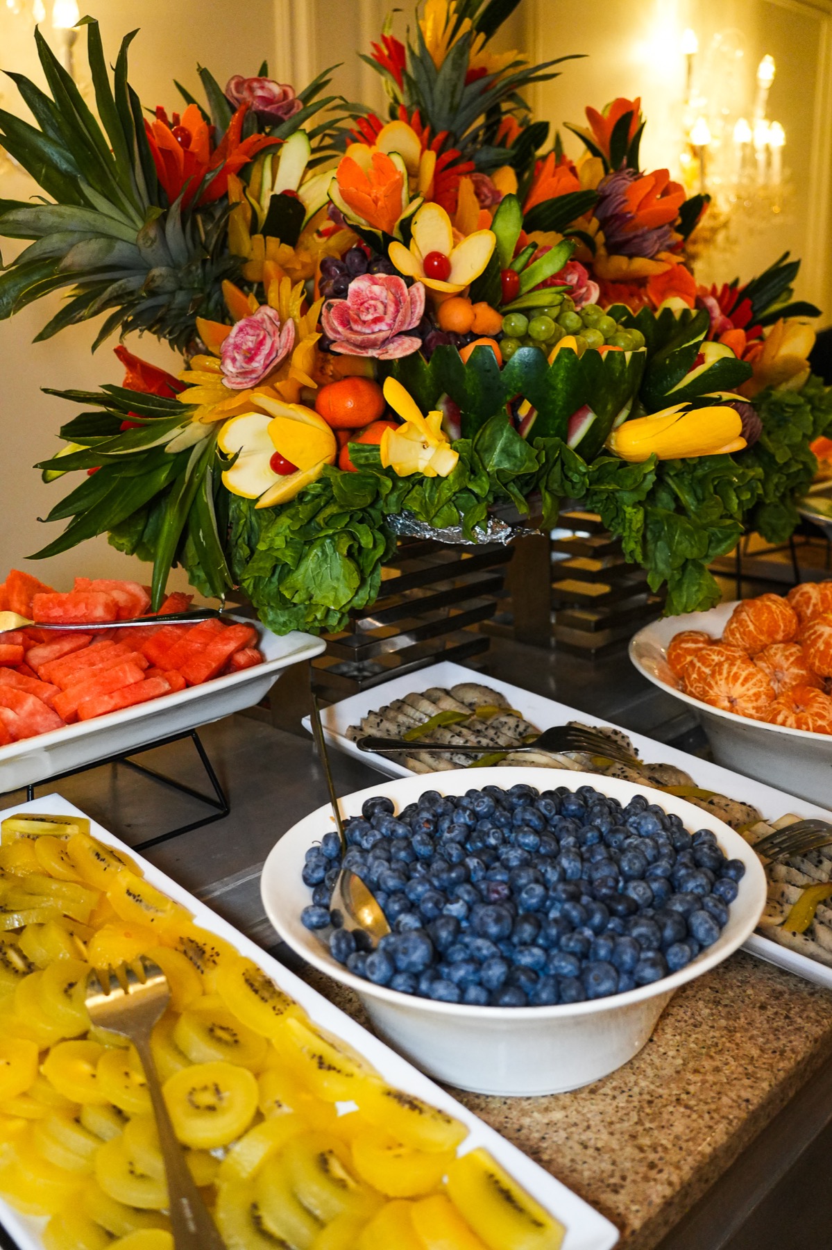 Fruit station display with carved produce and berries