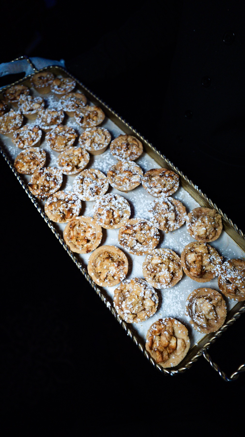 Mini apple tart desserts dusted with powdered sugar