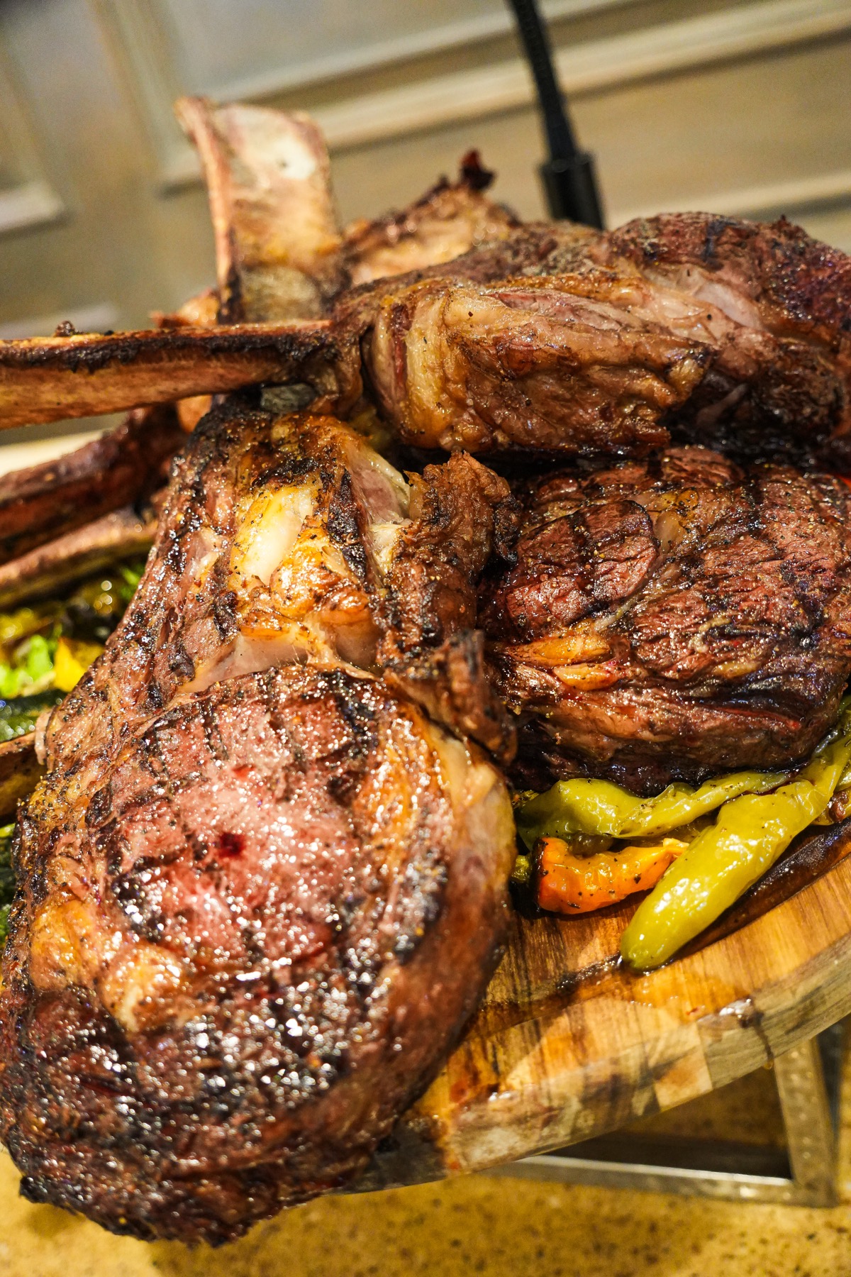 Close view of grilled ribeye on a kosher carving board