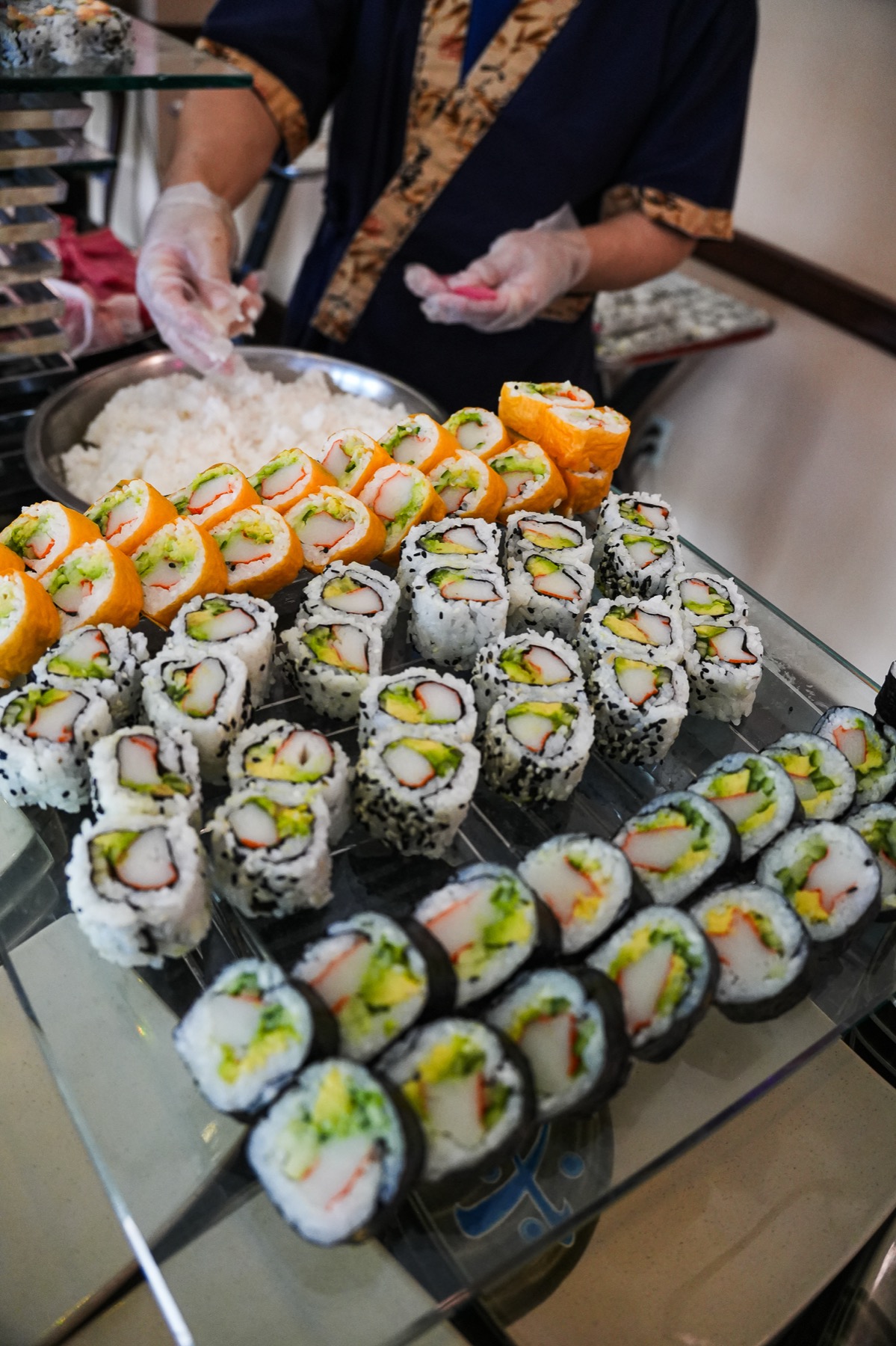 Kosher sushi rolls being prepared for service
