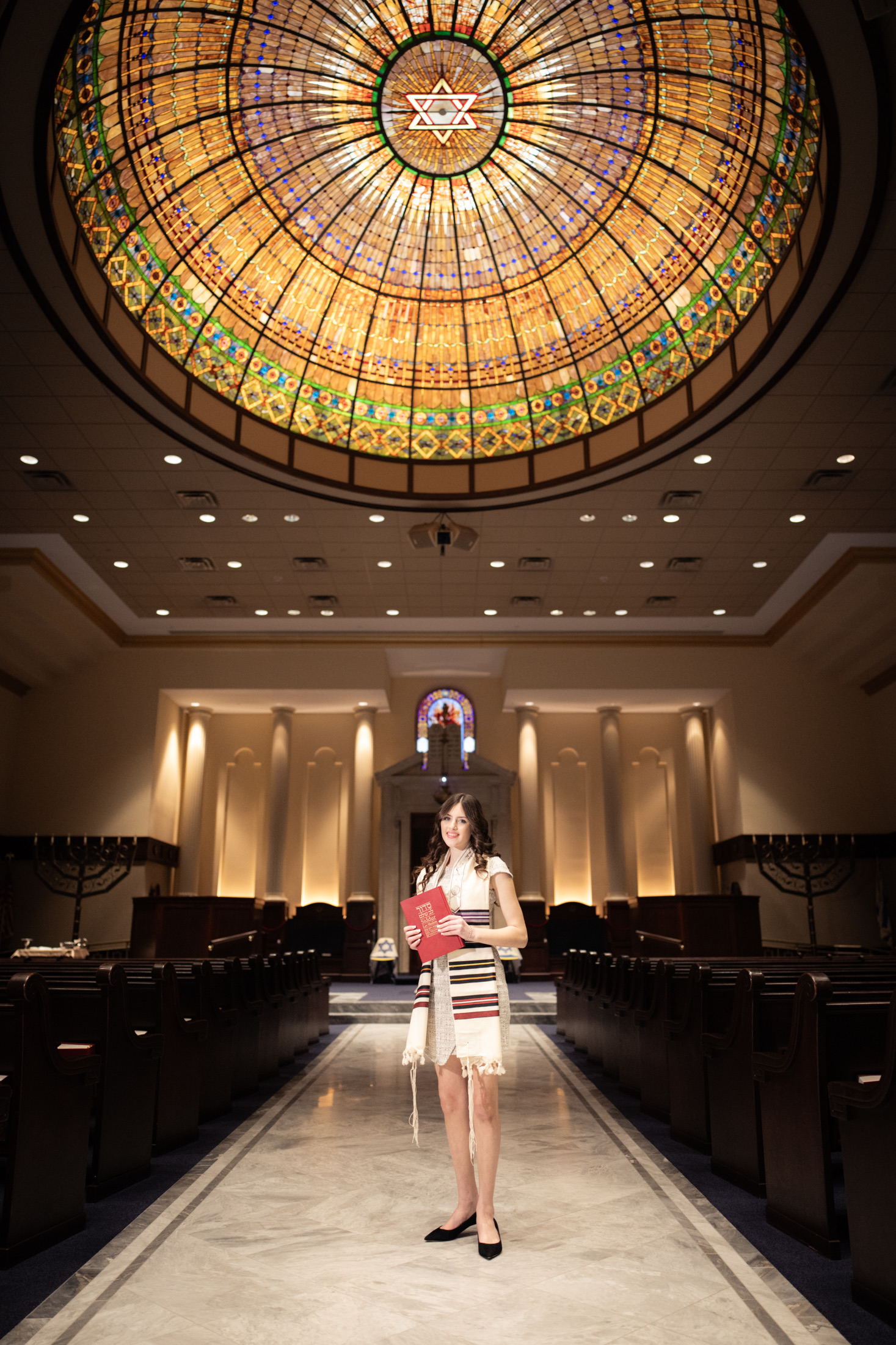Bat mitzvah portrait beneath the sanctuary stained-glass dome
