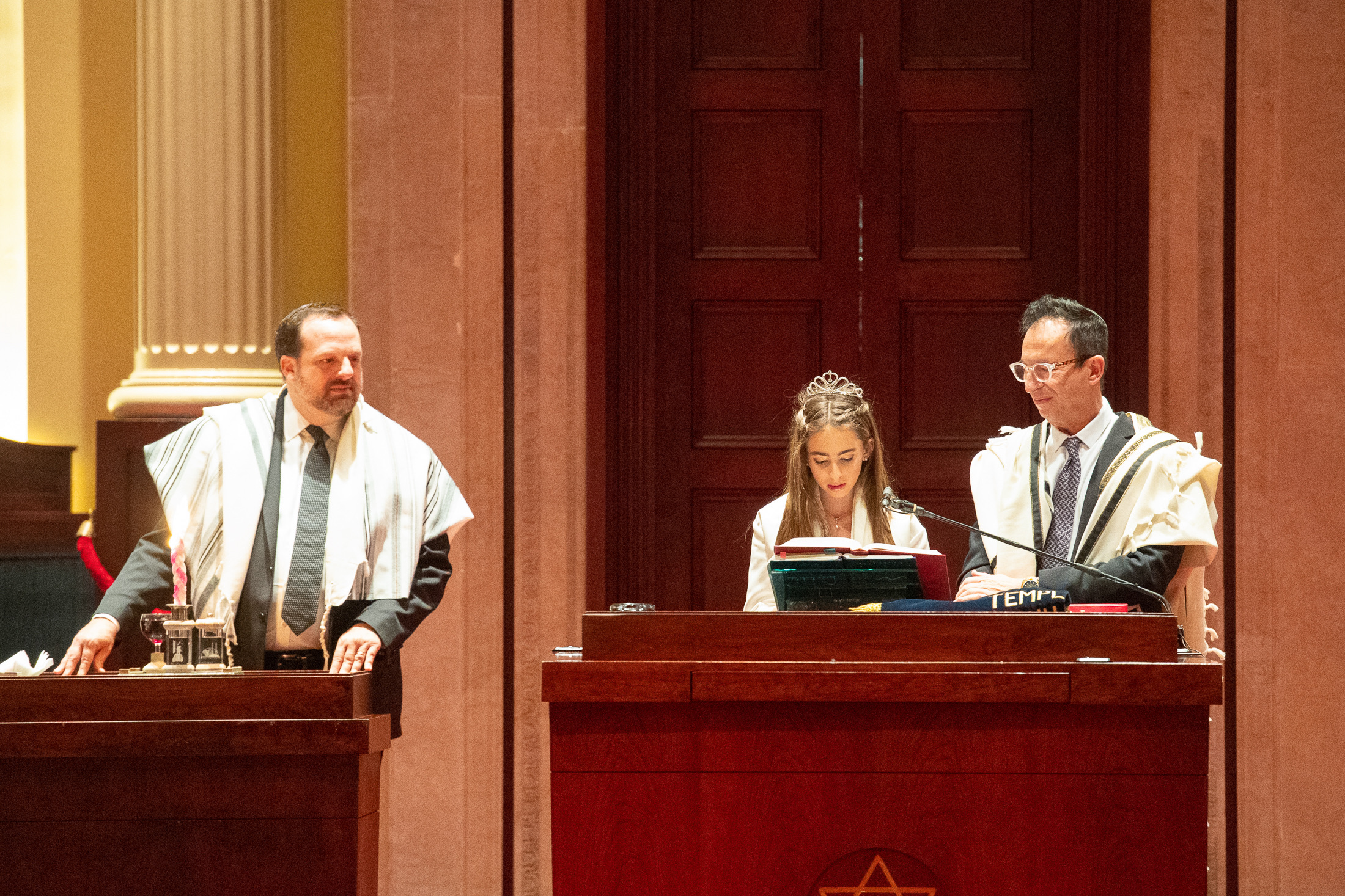 Girl reading from the Torah during her bat mitzvah service