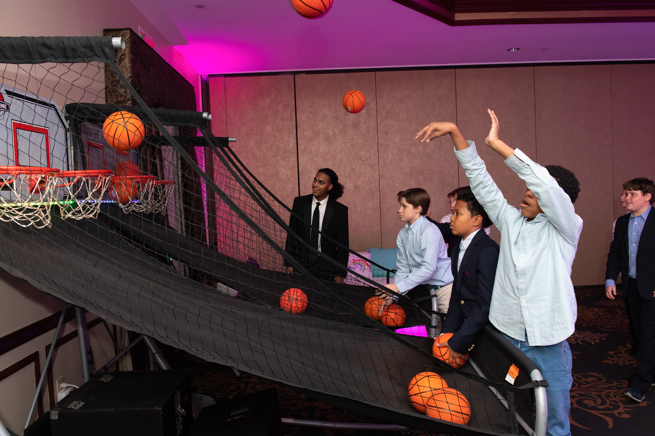 Young guests playing a basketball arcade game during the mitzvah party