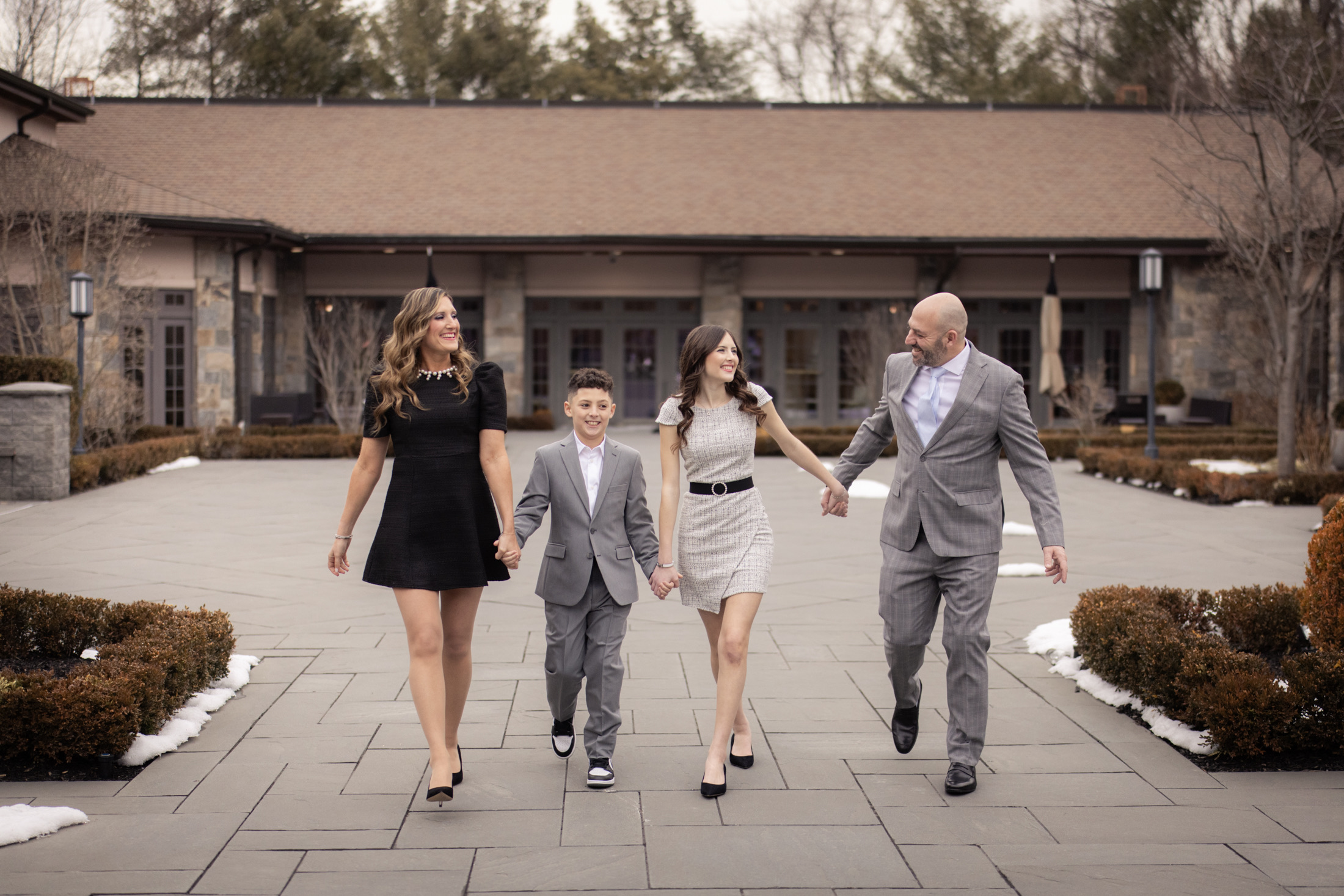 Mitzvah family walking together through the venue courtyard