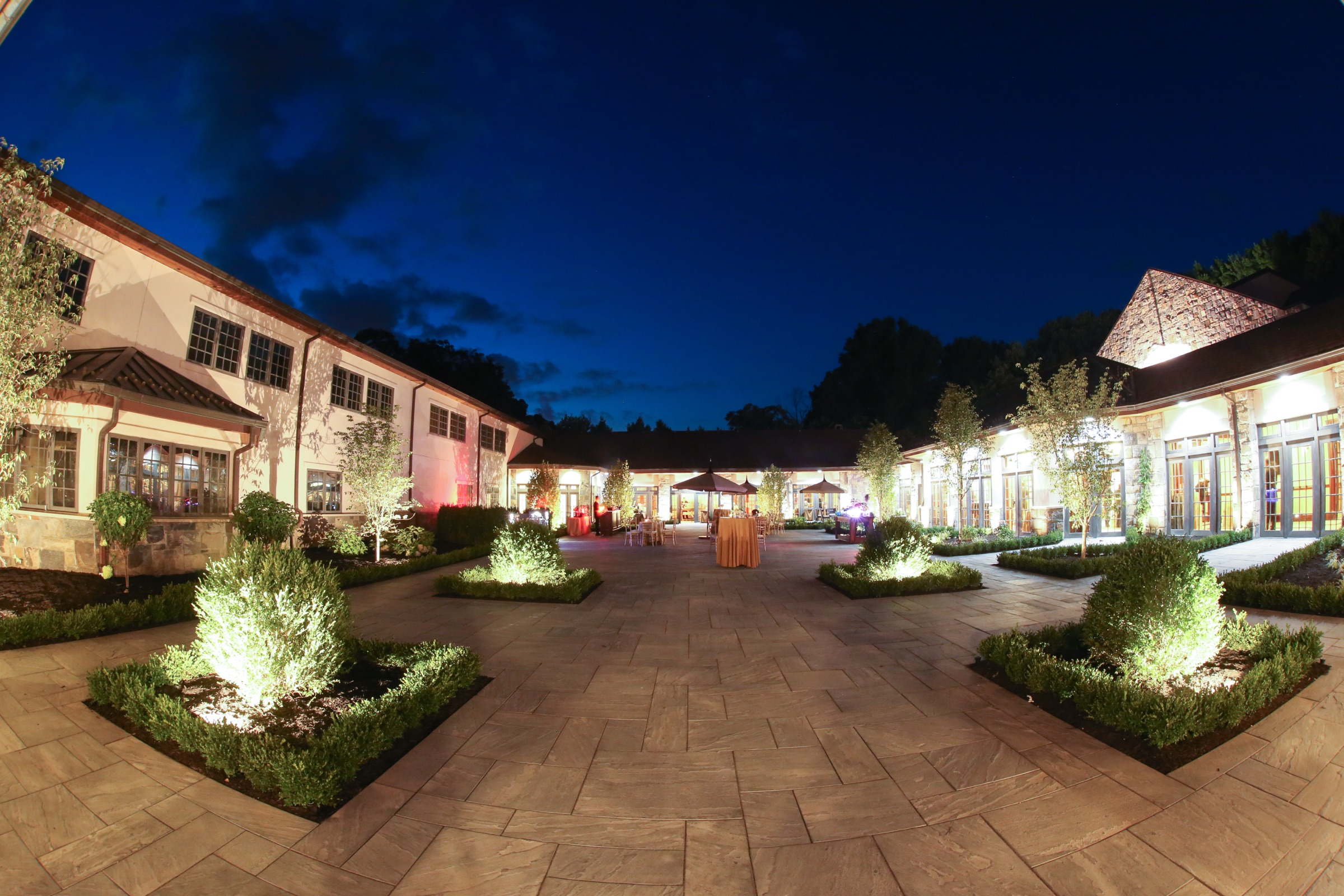 Outdoor courtyard illuminated for an evening celebration
