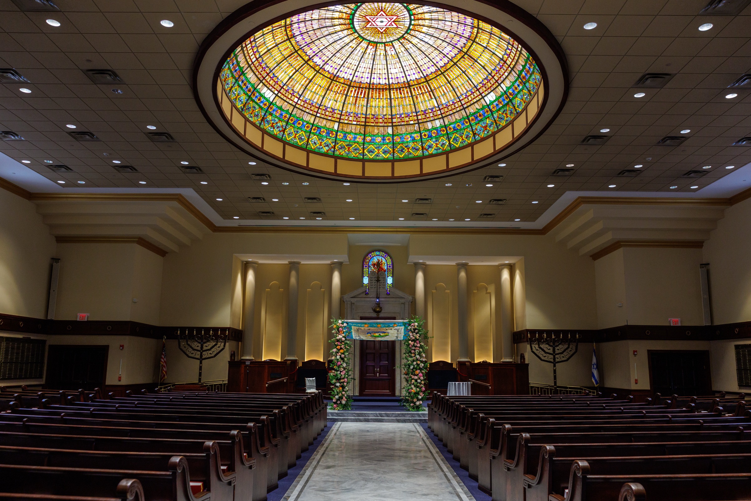Wide sanctuary view beneath the stained-glass dome