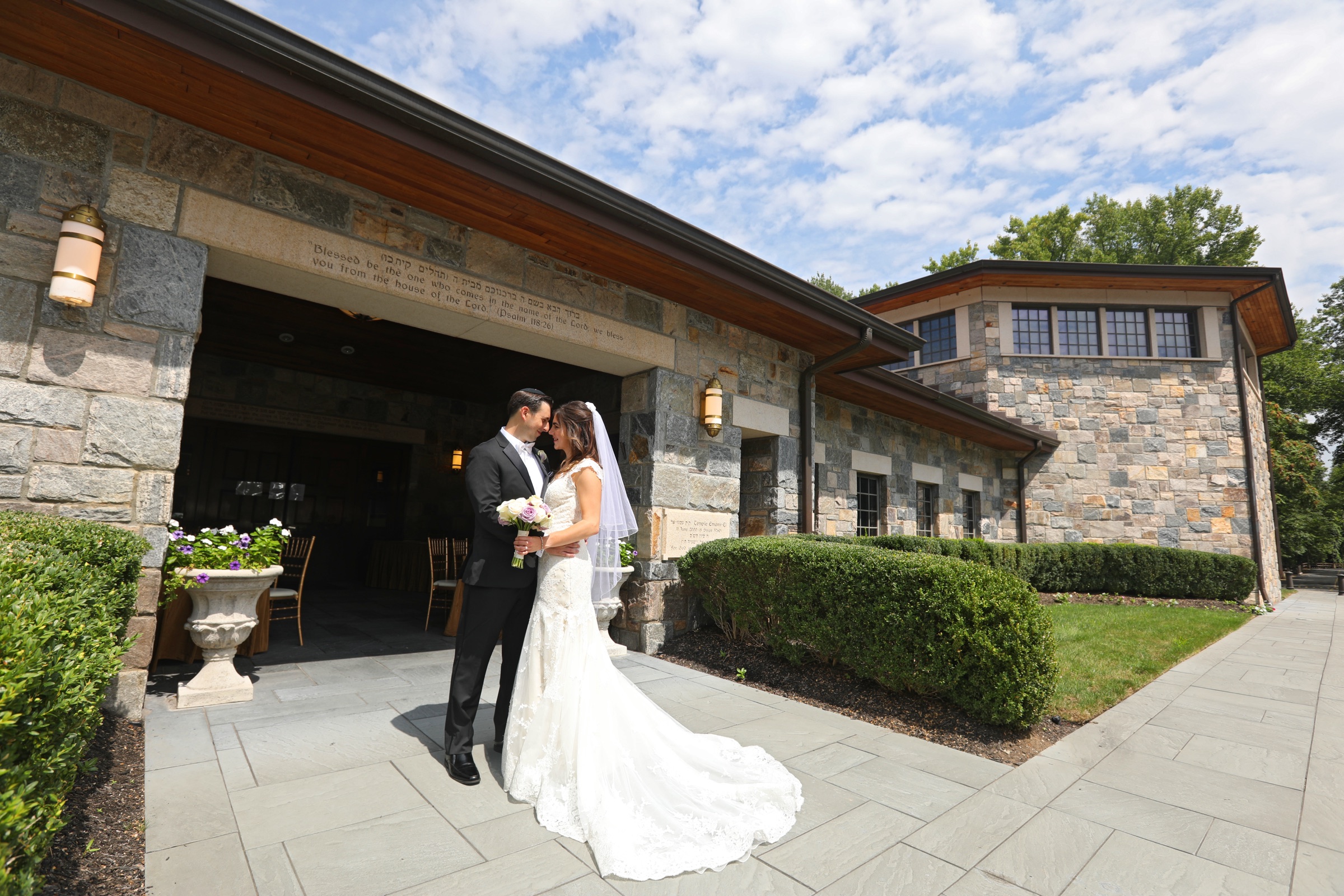 Newlyweds sharing a portrait outside the stone venue