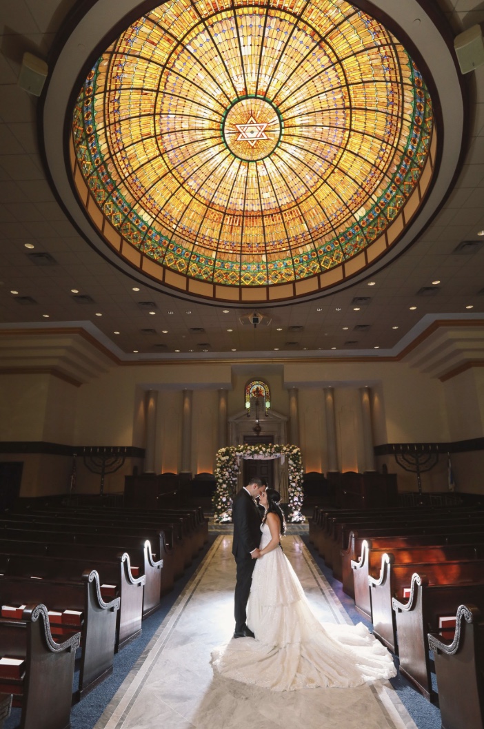 Bride and groom portrait beneath the stained-glass dome